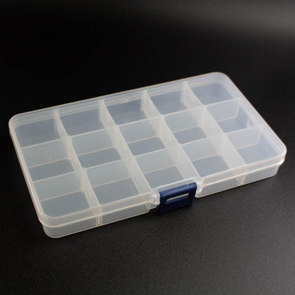 A clear plastic container with multiple compartments, sitting on a black surface.