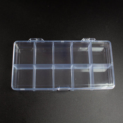 A clear plastic container with multiple compartments, sitting on a dark surface.