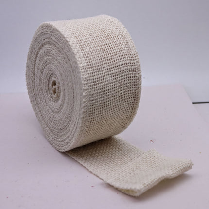 A roll of white twine or burlap is shown in the image, lying on a white surface.