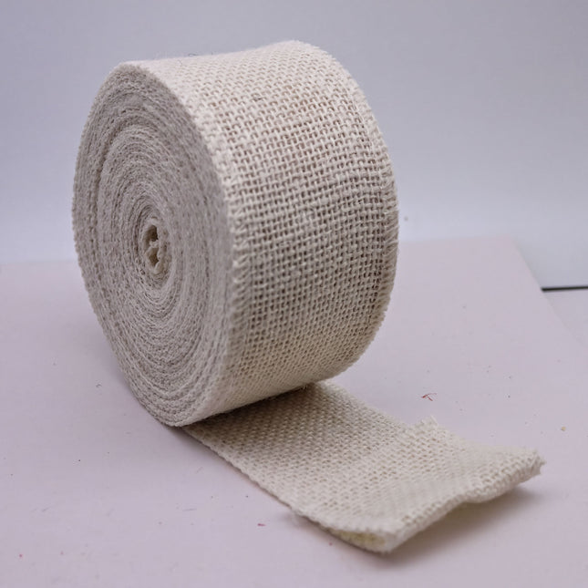 A roll of white twine or burlap is shown in the image, lying on a white surface.