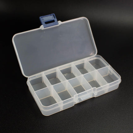 An open plastic container with multiple compartments, sitting on a black surface.