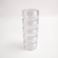 A clear plastic container with multiple compartments, standing upright on a white background.