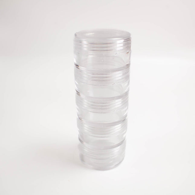 A clear plastic container with multiple compartments, standing upright on a white background.