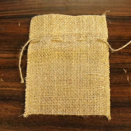 A piece of burlap or burlap-like material is placed on a wooden surface.