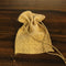 A burlap sack with a drawstring closure is placed on a wooden surface.