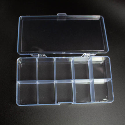 A clear plastic container with nine compartments is shown on a black surface.