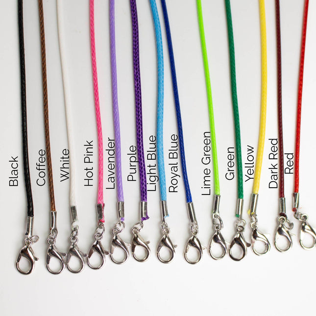 A collection of colorful braided strings or cords, each with a metal clasp, arranged in a row. The strings are labeled with different colors and are arranged in a visually appealing manner.
