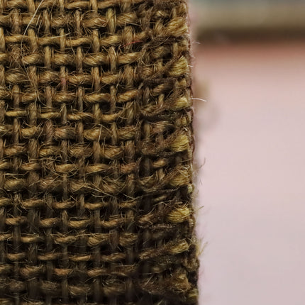 A close-up view of a woven fabric, with a textured and intricate pattern.