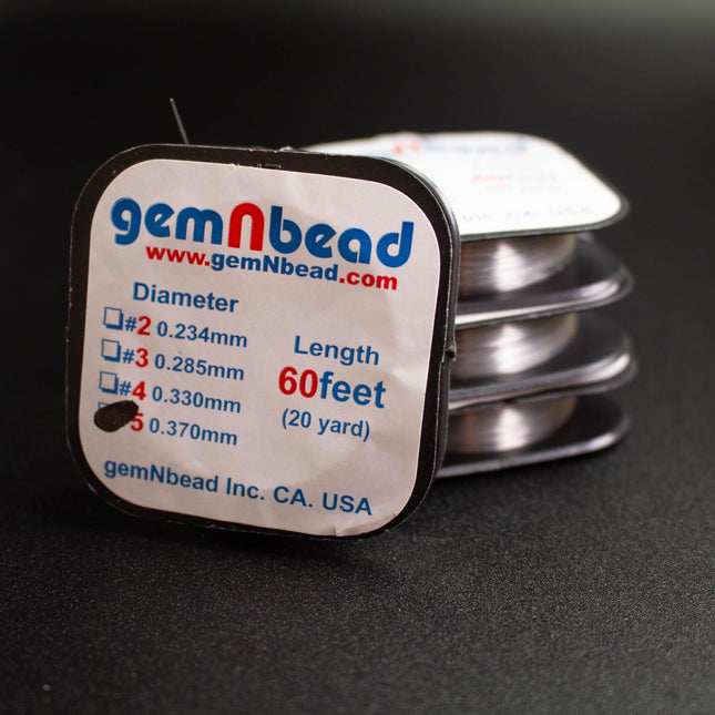 a close-up of a package of gemNbead thread, with the package label visible.
