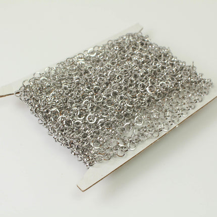 A spool of silver chain with numerous small links, likely used for jewelry or other decorative purposes.