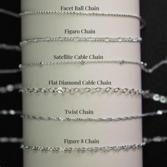 a collection of various silver chain necklaces, each with different designs and styles, arranged in a row.