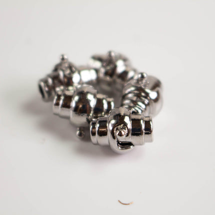 a close-up view of a shiny, metallic object with a unique, twisted design.
