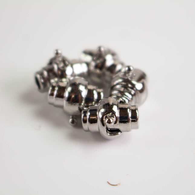 a close-up view of a shiny, metallic object with a unique, twisted design.