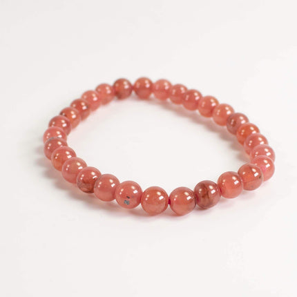 A bracelet made of small, round beads in a vibrant red color.