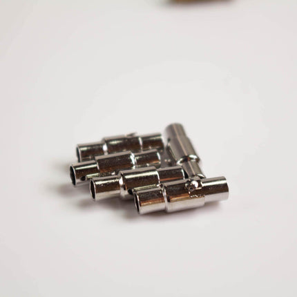 A close-up image of a group of silver-colored metal rods or tubes arranged in a pattern.