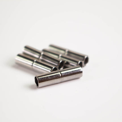 A group of silver-colored metal tubes or rods are arranged on a white background.