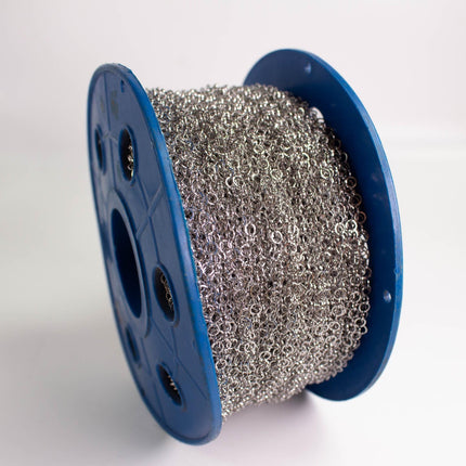 A spool of silver wire with a blue plastic spool is shown in the image.