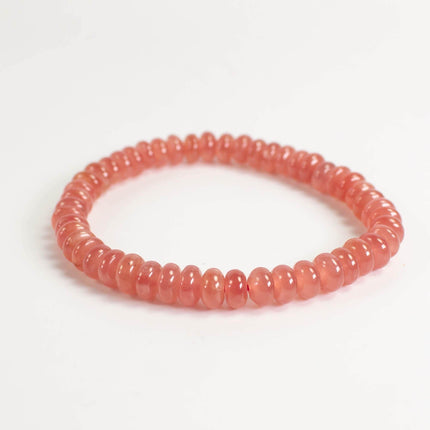 A bracelet made of small, round beads in a vibrant red color.